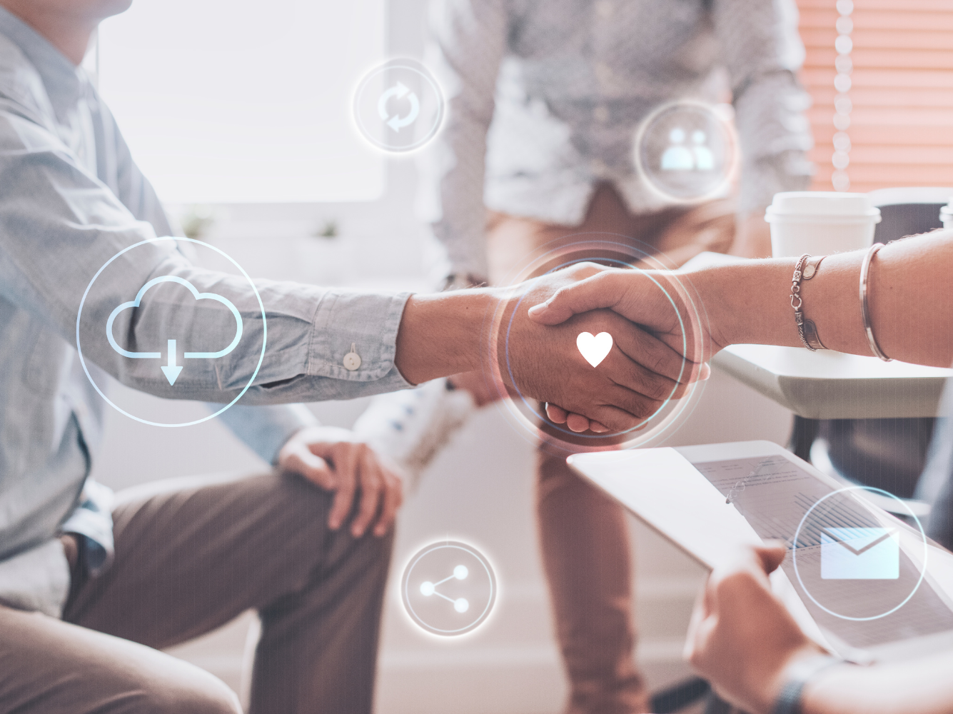 Close-up of two people shaking hands in a meeting, symbolizing partnership and collaboration for a Giving Tuesday initiative.